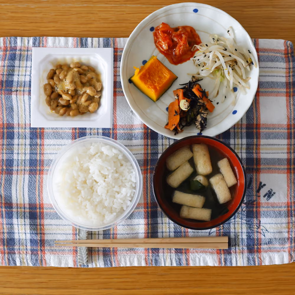 ごはん、納豆、味噌汁、キムチ、かぼちゃの煮物、もやしのナムル、ひじきの煮物