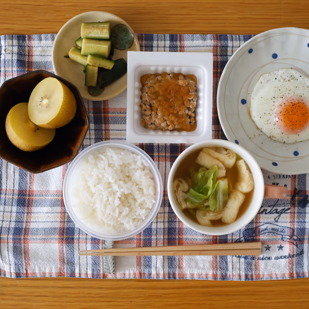 ごはん、納豆、目玉焼き、味噌汁、きゅうりの漬物、キウイ